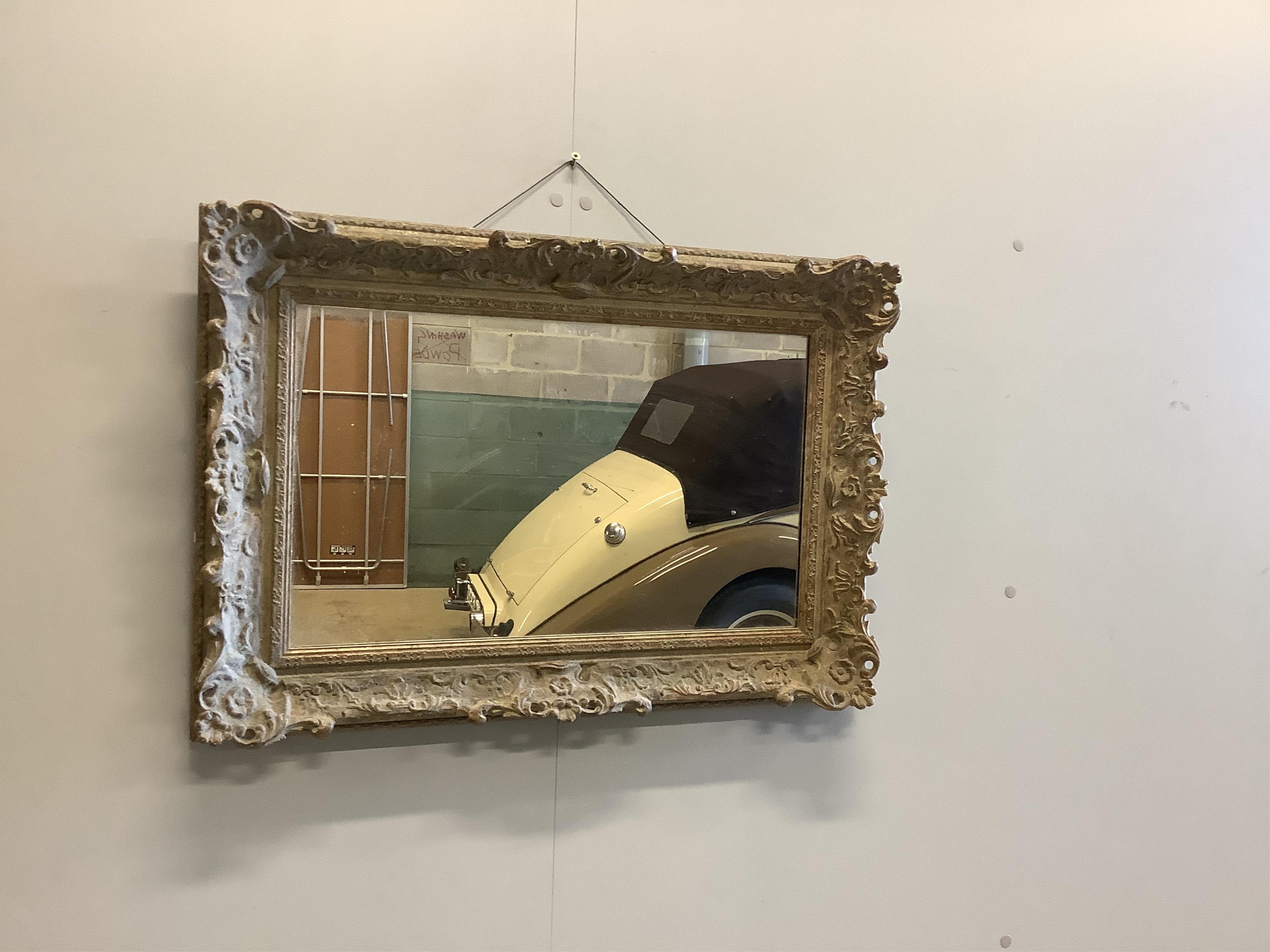 A Victorian style gilt composition rectangular wall mirror, width 73cm, height 51cm. Condition good.